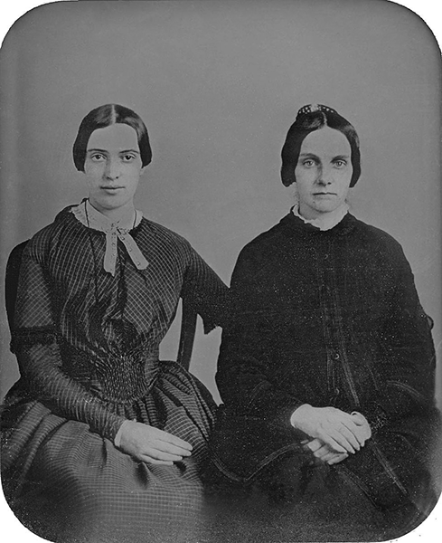 1859, Emily Dickinson (left) & Kate Scott Turner, via Wikimedia Commons.