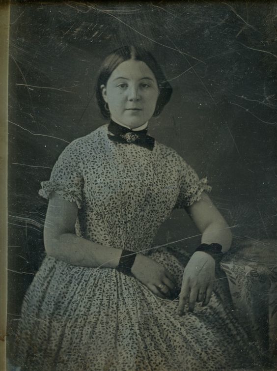 Unidentified young woman, in fancy floral dress, black velvet bracelets, and black ribbon about her neck with fancy brooch. Daguerreotype by Thomas M. Easterly, no date Missouri History Museum Archives. Easterly Daguerreotype Collection n17432