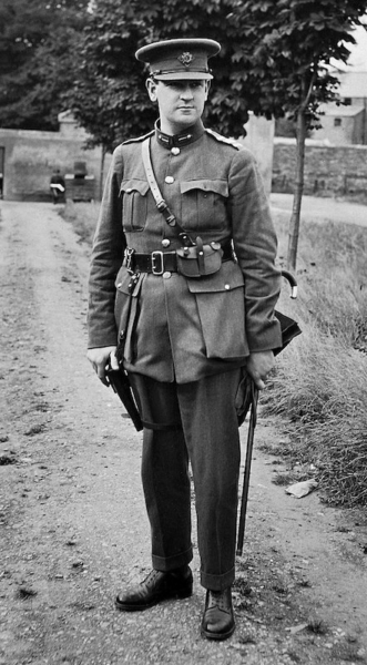 Irish revolutionary Michael Collins (1890 - 1922), leader in the Sinn Fein movement, stands outdoors on a dirt path, dressed in the uniform of Commander-in-Chief of the Irish National Forces, 1922, National Library of Ireland